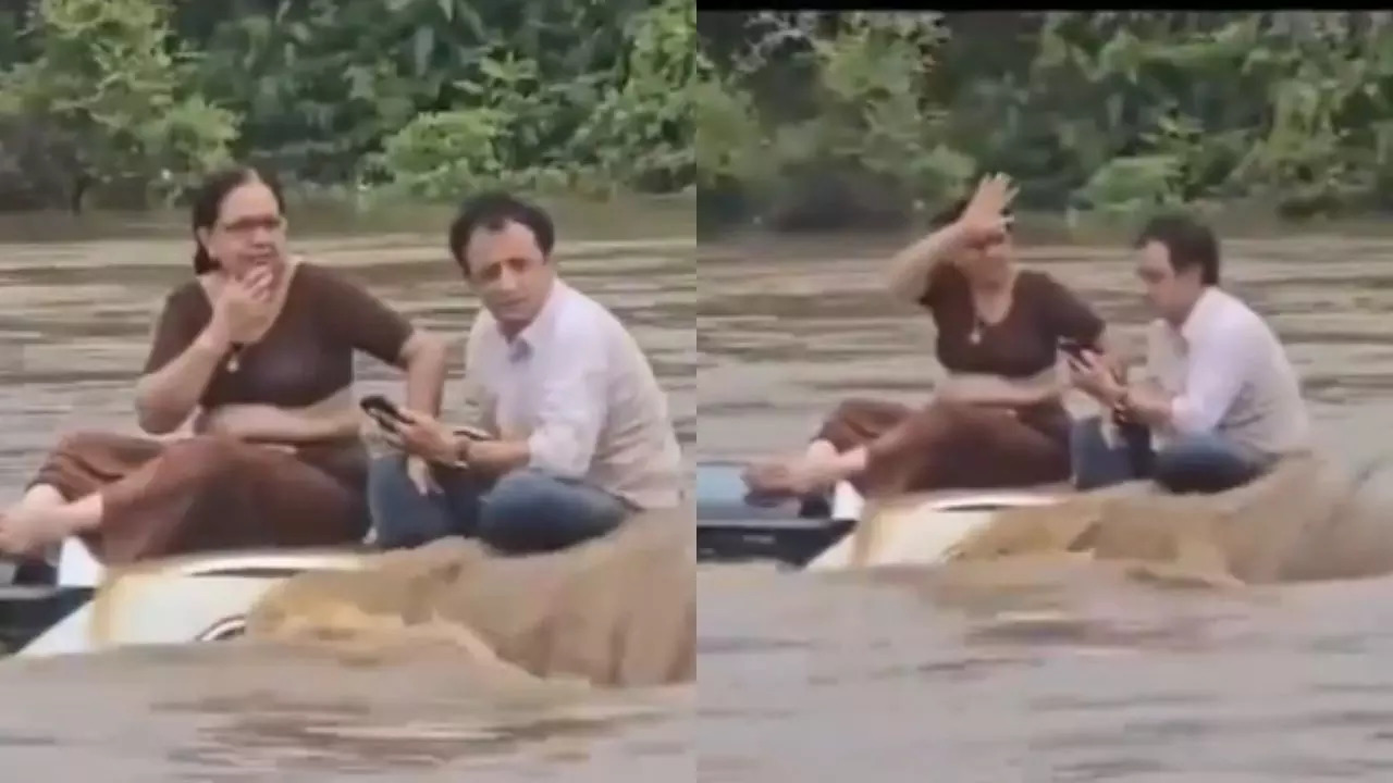 Suami isteri  terperangkap atas bumbung kereta dalam banjir